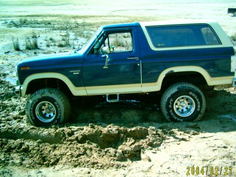 1985 Ford Bronco - Ford Bronco stuck in mud during a clay pit trip. The vehicle's body style suggests an early 1980s model.