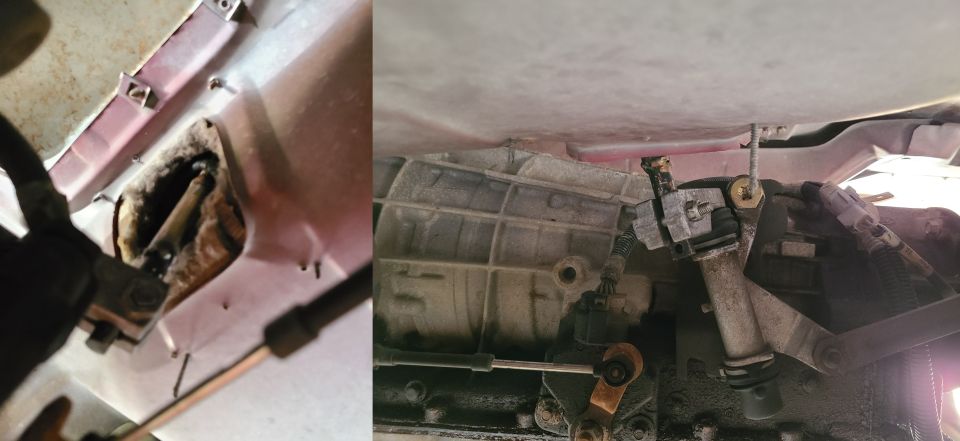 Close-up of car transmission linkage components and cables, with SuperMotors logo visible