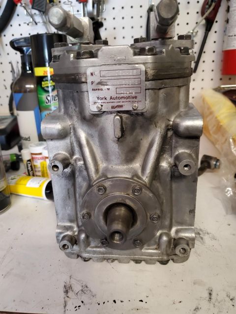 1996 Ford Bronco - This York Automotive air conditioning compressor has a metal data plate with part information.