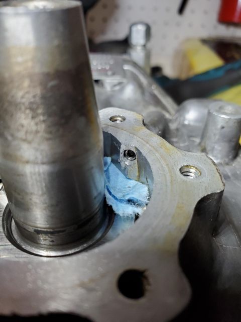 1996 Ford Bronco - A blue rag is stuffed into a hole on a metal engine part.