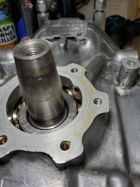 1996 Ford Bronco - Close-up of a metal component with a bearing and threaded shaft.