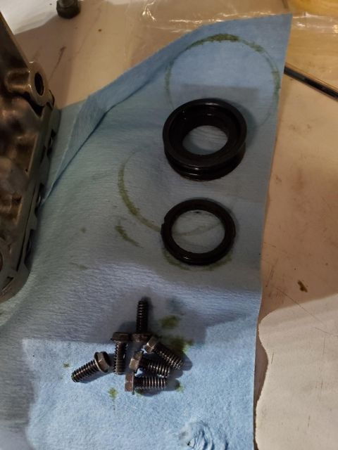 1996 Ford Bronco - Disassembled engine components and fasteners are arranged on a towel, suggesting maintenance or repair work.