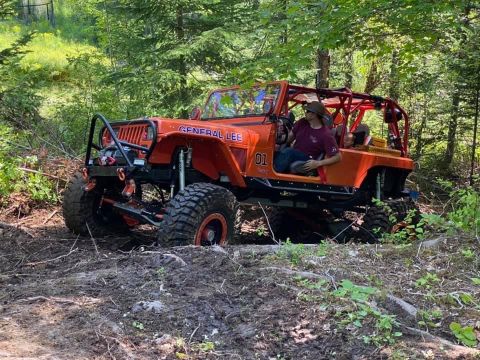 1992 Jeep Wrangler - Modified 1992 Jeep Wrangler, nicknamed 'General Lee', navigates an off-road trail.