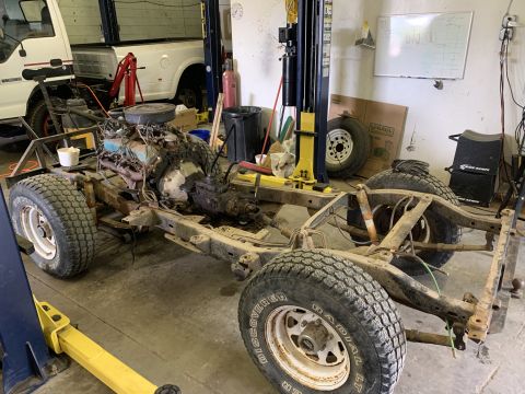 1979 Jeep CJ5 - This 1979 Jeep CJ5 chassis is undergoing work in a garage, with the engine and transmission out.
