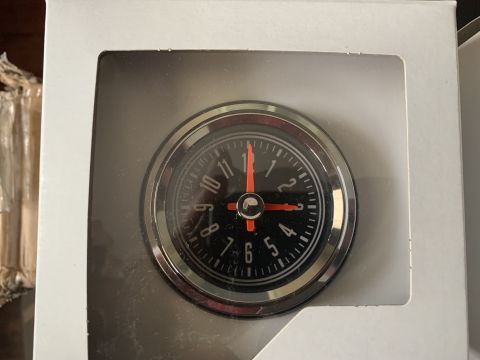 1979 Jeep CJ5 - This is a close-up of a car clock, likely an aftermarket part, with a black face and chrome trim.