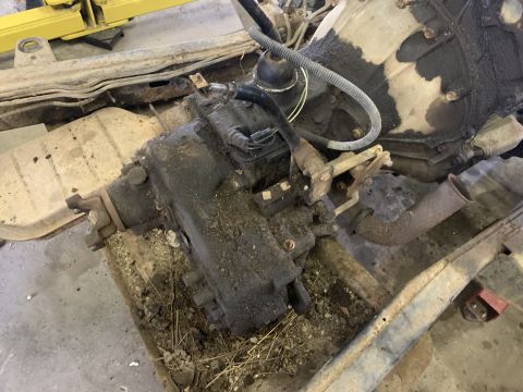 1979 Jeep CJ5 - Close-up view of a greasy transfer case and transmission assembly, likely from an older vehicle.