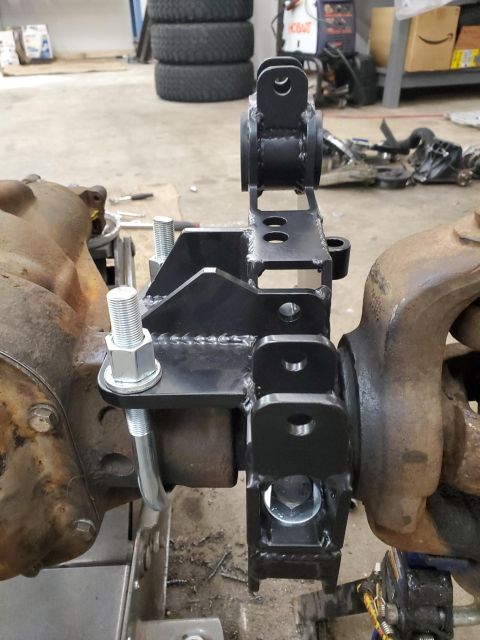 1996 Ford Bronco - Custom suspension bracket installed on a vehicle's axle, likely for off-road modification.