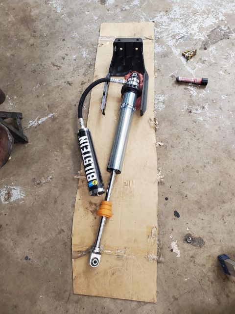 1996 Ford Bronco - A Bilstein shock absorber assembly, likely for off-road use, is shown on a concrete floor.