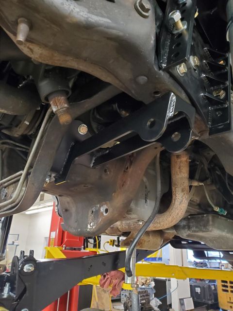1996 Ford Bronco - Custom suspension bracket installed on vehicle undercarriage, likely for an off-road modification.