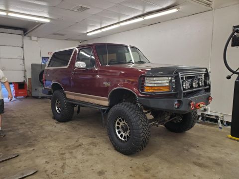1996 Ford Bronco - This modified Ford Bronco features a lifted suspension and custom bumper, indicating a model year earlier than claimed.