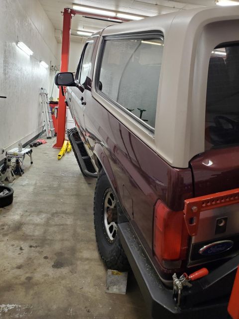 1996 Ford Bronco - 1996 Ford Bronco parked in a garage with a vehicle lift.