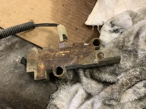 1979 Jeep CJ5 - Close-up of a rusty brake proportioning valve, likely removed from a vehicle for repair or replacement.
