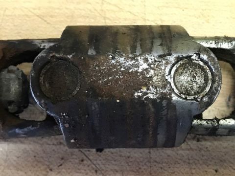 2000 Ford Explorer - A close-up view of a greasy and corroded steering linkage component, showing signs of wear and tear.