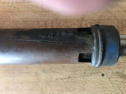 2000 Ford Explorer - A close-up view of a steering shaft exhibiting a significant crack along its length.