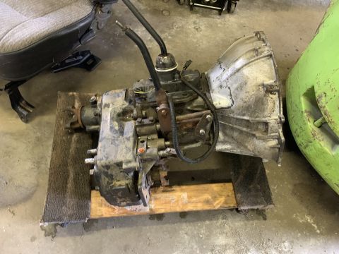 1979 Jeep CJ5 - Transmission and transfer case assembly shown on a wooden pallet.