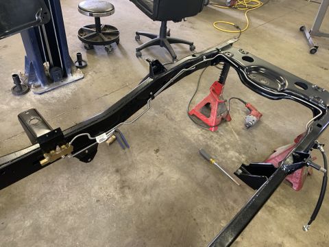 1979 Jeep CJ5 - Jeep CJ5 frame undergoing restoration, showing brake lines and a proportioning valve.