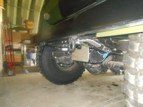 1992 Ford Bronco - Close-up view of the rear axle and tire assembly of a heavy-duty vehicle, with visible suspension and hitch components.