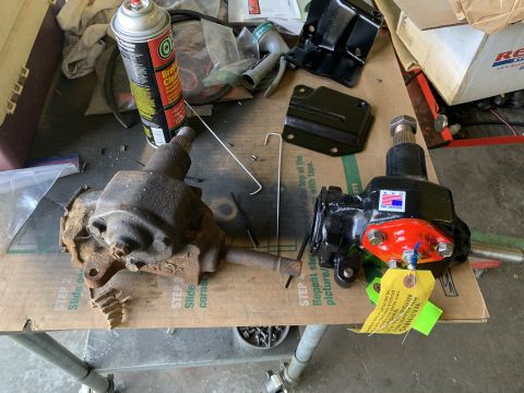 1979 Jeep CJ5 - Comparison of a rusty old steering gearbox next to a freshly rebuilt unit with an American flag decal.
