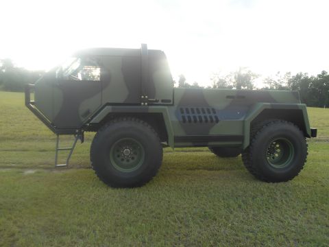 1992 Ford Bronco - This military-style truck features a camouflage paint scheme and heavy-duty off-road tires.