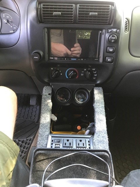 2000 Ford Explorer - The vehicle's interior features an aftermarket entertainment system and additional power outlets.