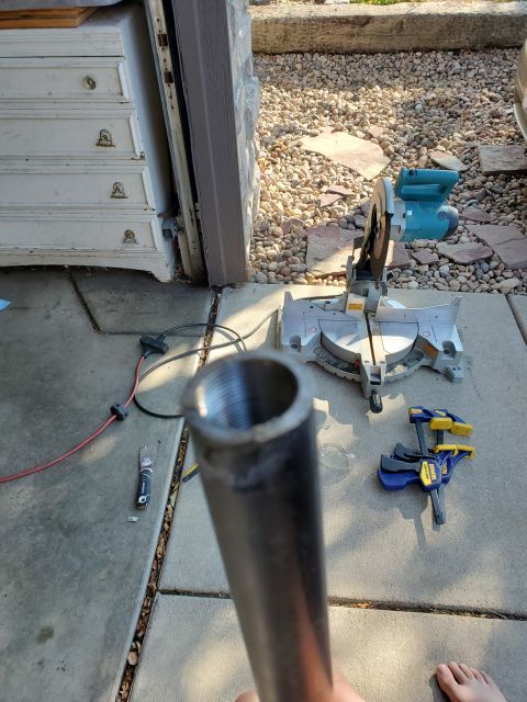 1996 Ford Bronco - Metal pipe with threaded end, with a miter saw and clamps in the background.