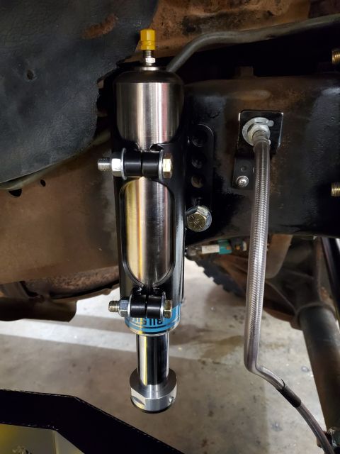 1996 Ford Bronco - Close-up of an aftermarket Bilstein shock absorber assembly installed on a vehicle.