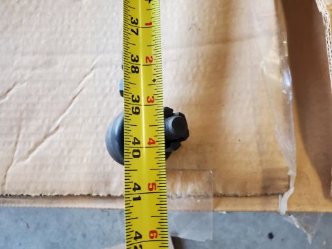 1996 Ford Bronco - A tie rod end is measured with a tape measure, indicating its size.