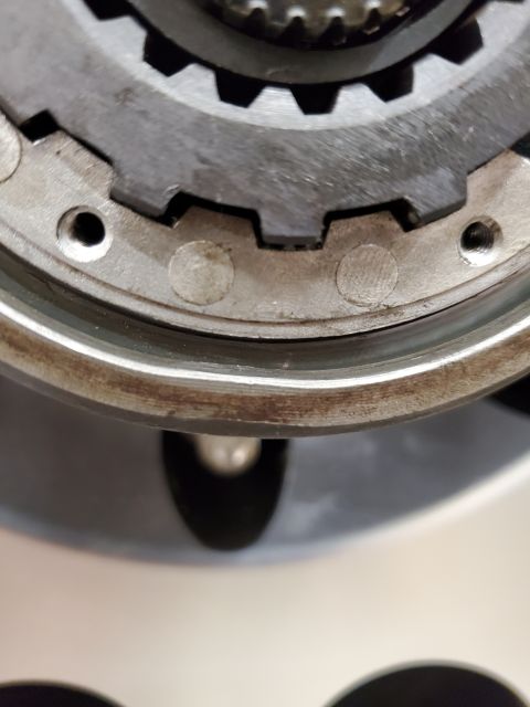 1996 Ford Bronco - Detail of a vehicle's transmission or drivetrain component, showing interlocking gears and mounting holes.