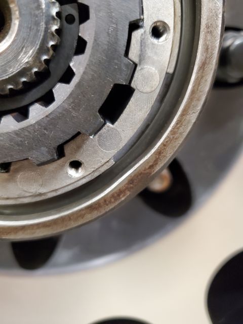 1996 Ford Bronco - A close-up view of a metal gear mechanism, showing its intricate teeth and a rusty outer rim.
