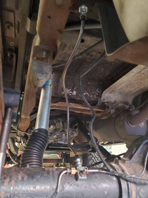 1996 Ford Bronco - This photo shows the undercarriage of a vehicle, focusing on suspension and drivetrain components.