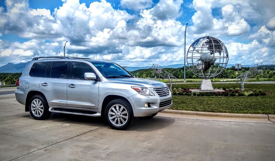 Silver 2008 Lexus LX 470 parked on pavement with a large globe sculpture in the background