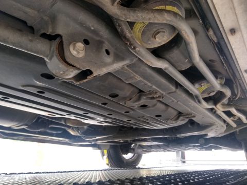 2008 Lexus LX 470 - The underside of a vehicle reveals its suspension, exhaust, and underbody protection.