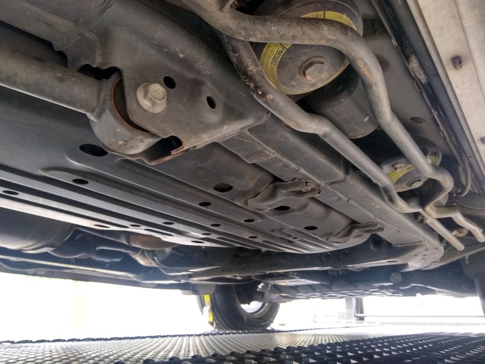 Undercarriage view showing suspension components and exhaust system