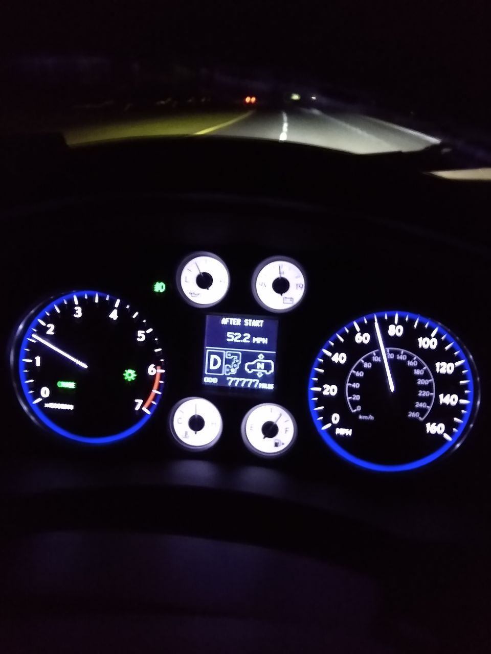 Dashboard gauges showing 52.2 mph and 77777 miles