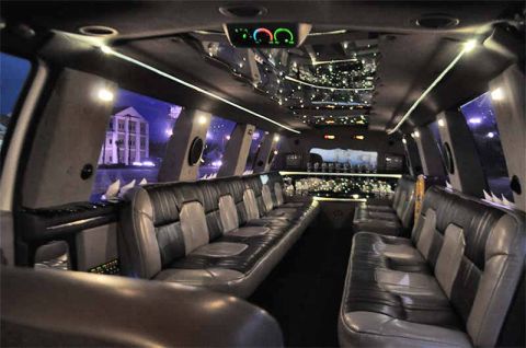 2000 Ford Excursion - Limousine interior features plush seating, ambient lighting, and a full bar setup.