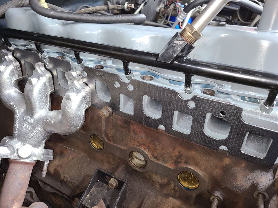 This modern [url=https://www.amazon.com/dp/B005ETQBQE]graphite combination gasket[/url] is the only exhaust gasket I'd use on any Ford engine. V8s use NO ex.man. gasket.