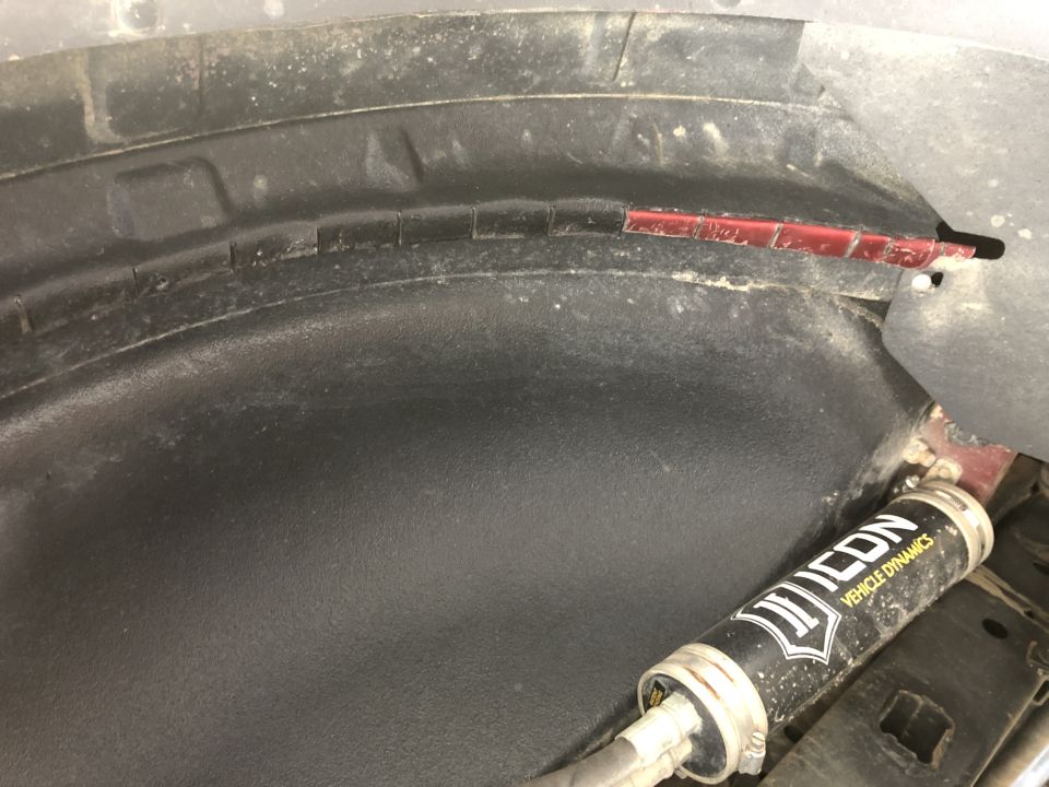 Wheel well liner with Icon Vehicle Dynamics shock absorber visible