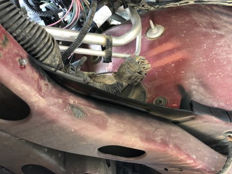 2014 Ford F-150 - A close-up view of a vehicle's internal wiring and frame components, with a watermark indicating the source.