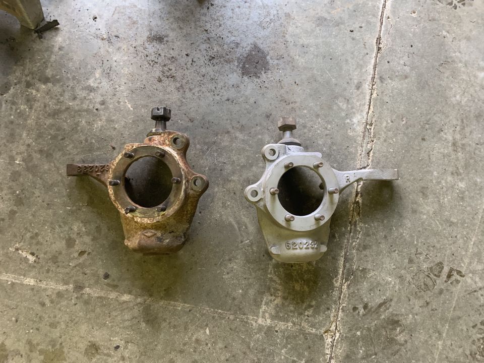 Two steering knuckles, one rusty and one clean, with part number 620249 visible on the clean one