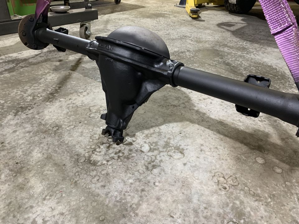 black rear axle assembly with differential housing and driveshaft yoke