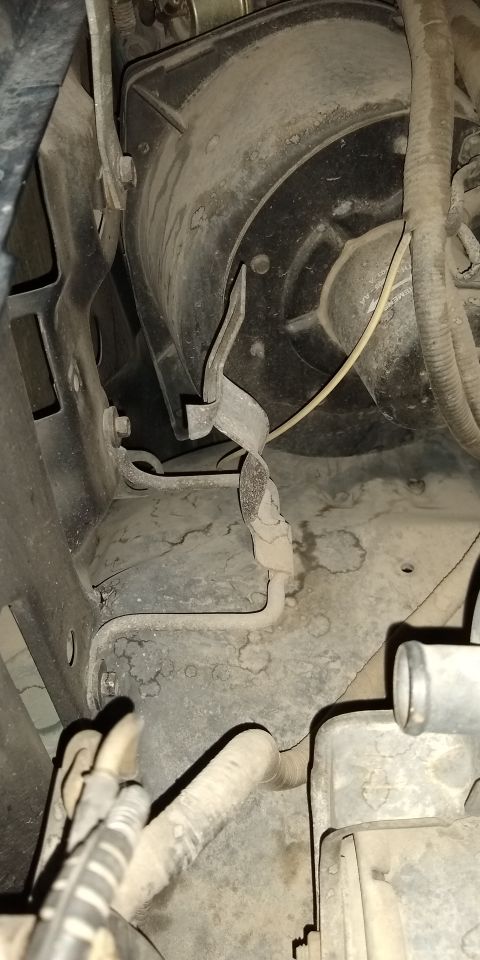 1993 Ford Bronco - Under hood left side wall empty Jack storage/stow hinged holder, swung to OPEN position (secure with wing nut) in 1993 Ford Bronco XLT 5.8L