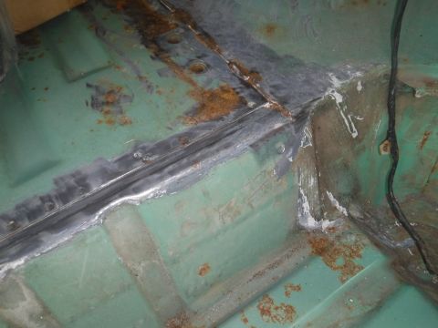 1992 Ford Bronco - Sloppy seam sealer caked on all around the driver's b-pillar base.