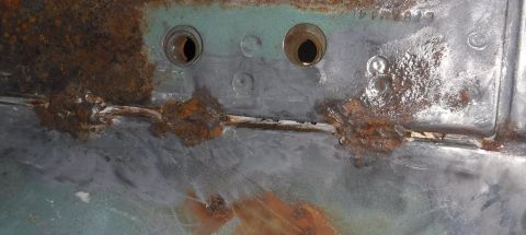 1992 Ford Bronco - Passenger rear seat bracket / bed rail panel gap. It's a little tough to tell, but that's gravel down below, viewed through the gap between…