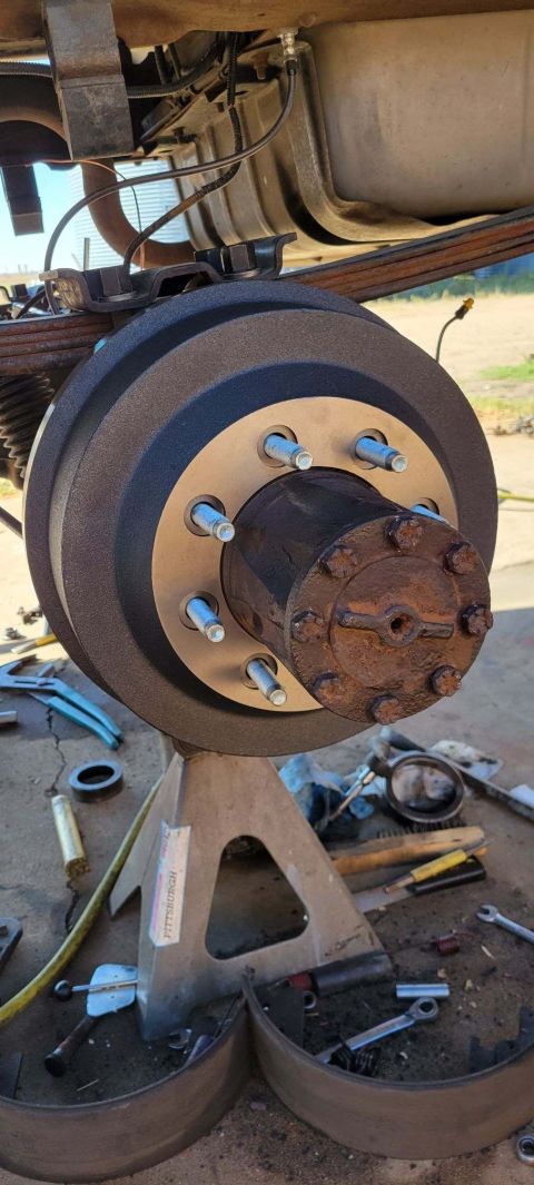 1996 Ford Bronco - A close-up view of a vehicle's suspension and wheel assembly, showing worn parts.