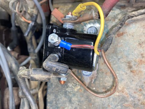 1976 Ford Bronco - Close-up view of a starter solenoid, a crucial component for igniting a vehicle's engine.