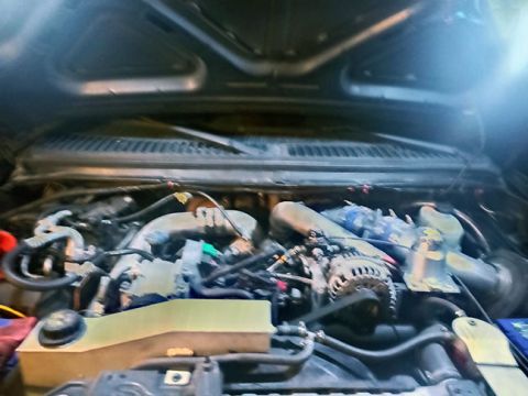 2001 Ford Excursion - The engine bay of a vehicle is shown, with a watermark for SuperMotors.net visible at the bottom right.