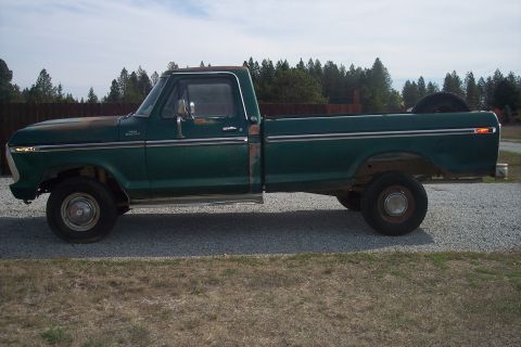 1977 Ford F-150 - A green 1977 Ford F-150 pickup truck is parked on a gravel surface with a wooded area in the background.