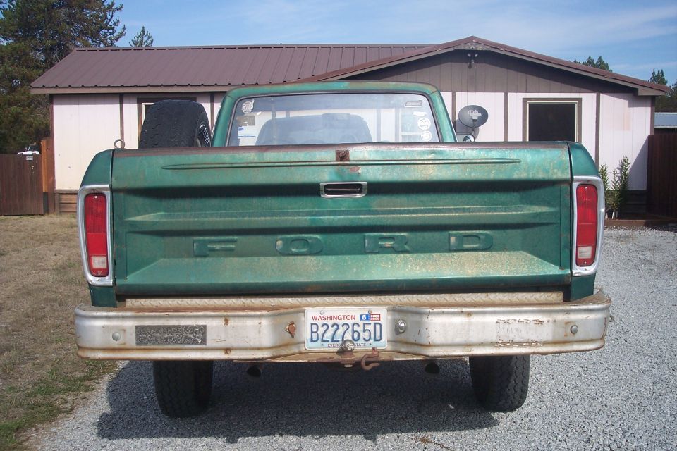 1977 Ford F-150 pickup truck rear view, green paint, spare tire in bed, Washington license plate B22265D