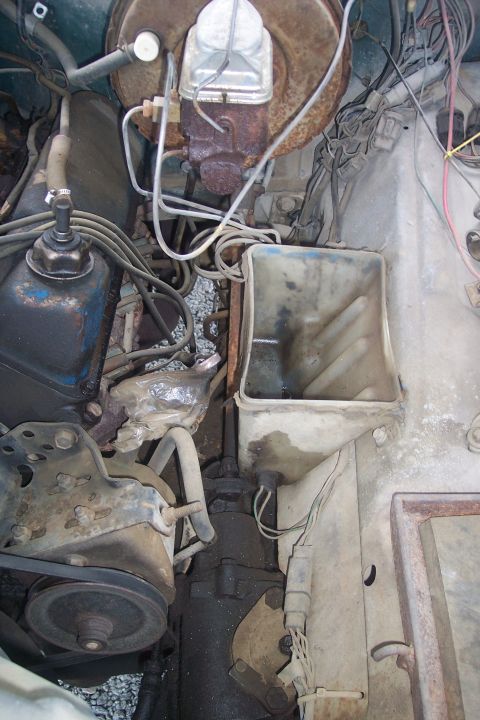 1977 Ford F-150 - Close-up view of the engine bay, showing the brake master cylinder and various hoses and wiring.