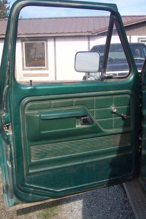 1977 Ford F-150 - Interior view of a green truck door, with another vehicle seen through the opening.